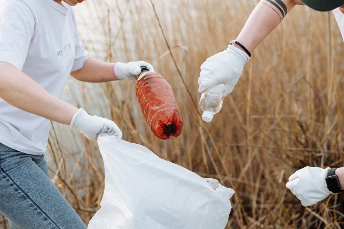 Two people picking up trash 